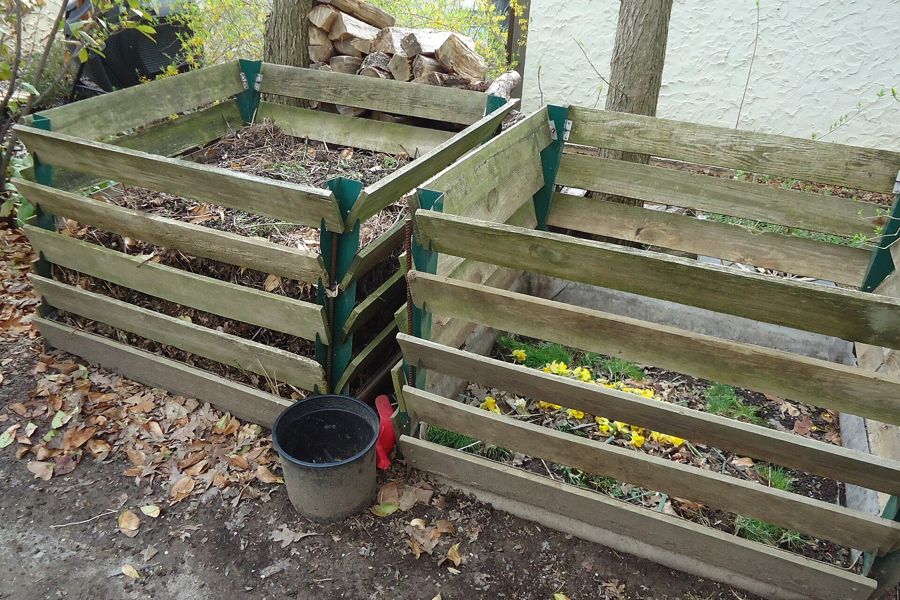 Backyard compost containers with garden waste in a New Jersey yard